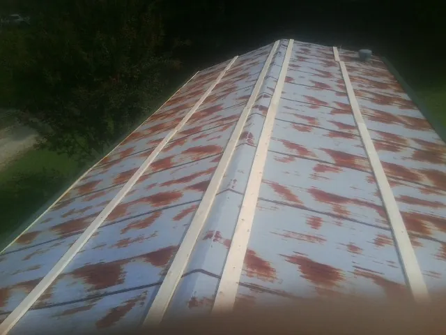 Rusted metal roof panels with new wood purlins before replacement — Storm Damage Roof Repair in Loughman by Roofing Brothers